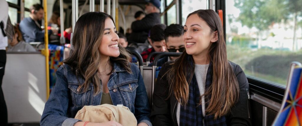 Image of two college students on a Metro vehicle.