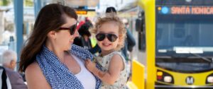 Mother with daughter next to Metro rail train.