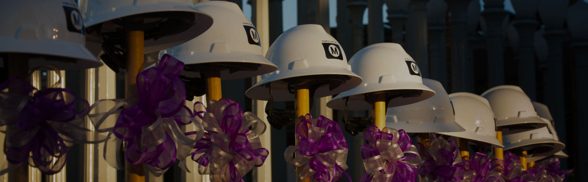 Metro safety helmets hanging on shovels during a groundbreaking ceremony.