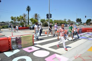Several individuals crossing the street in a crosswalk